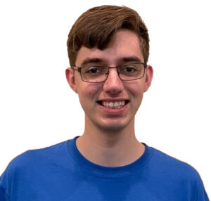 A headshot of Logan Dutro, wearing a blue shirt with his glasses